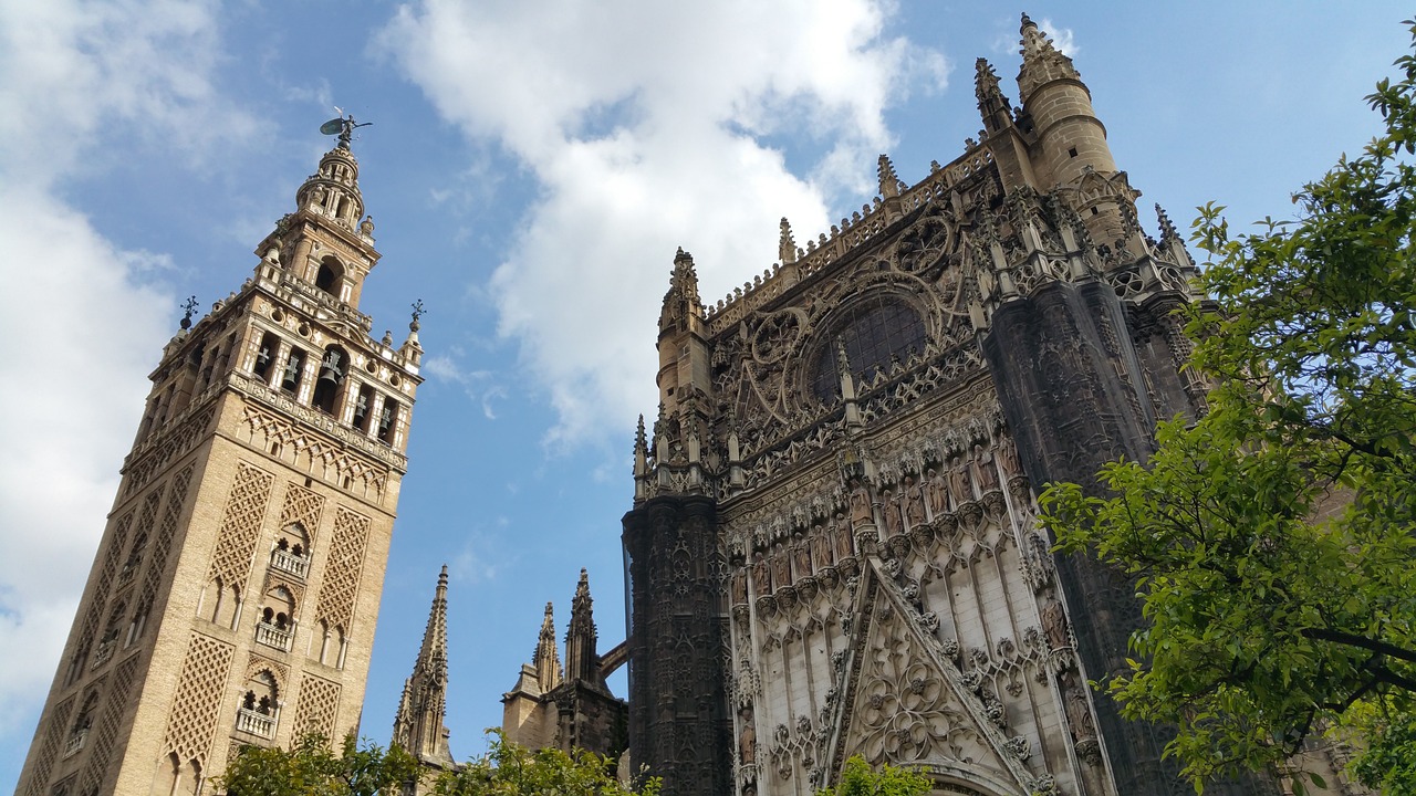 The towering Giralda bell tower against a bright blue sky in Seville